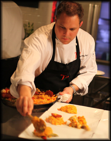 Chef Farina serving Paella at COOK.